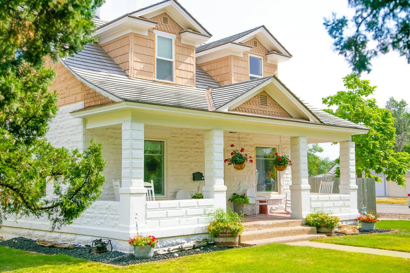 A white and cedar craftsman bungalow with a deep front porch, the sample listing flip is reading